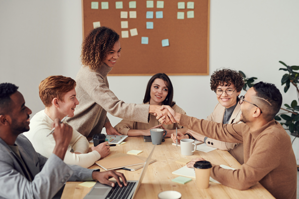 Photo of proffesionals sitting around an office conference table